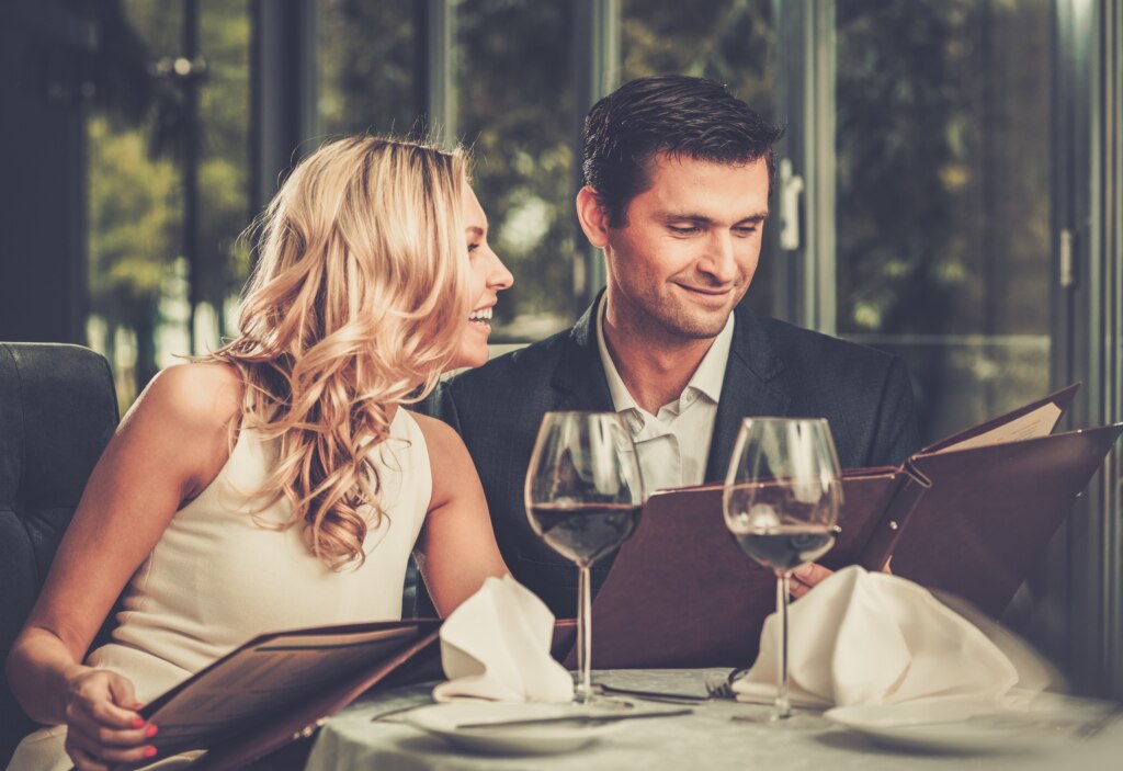 Cheerful couple with menu in a restaurant